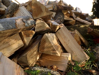 Pile of dry firewood outdoors, closeup view
