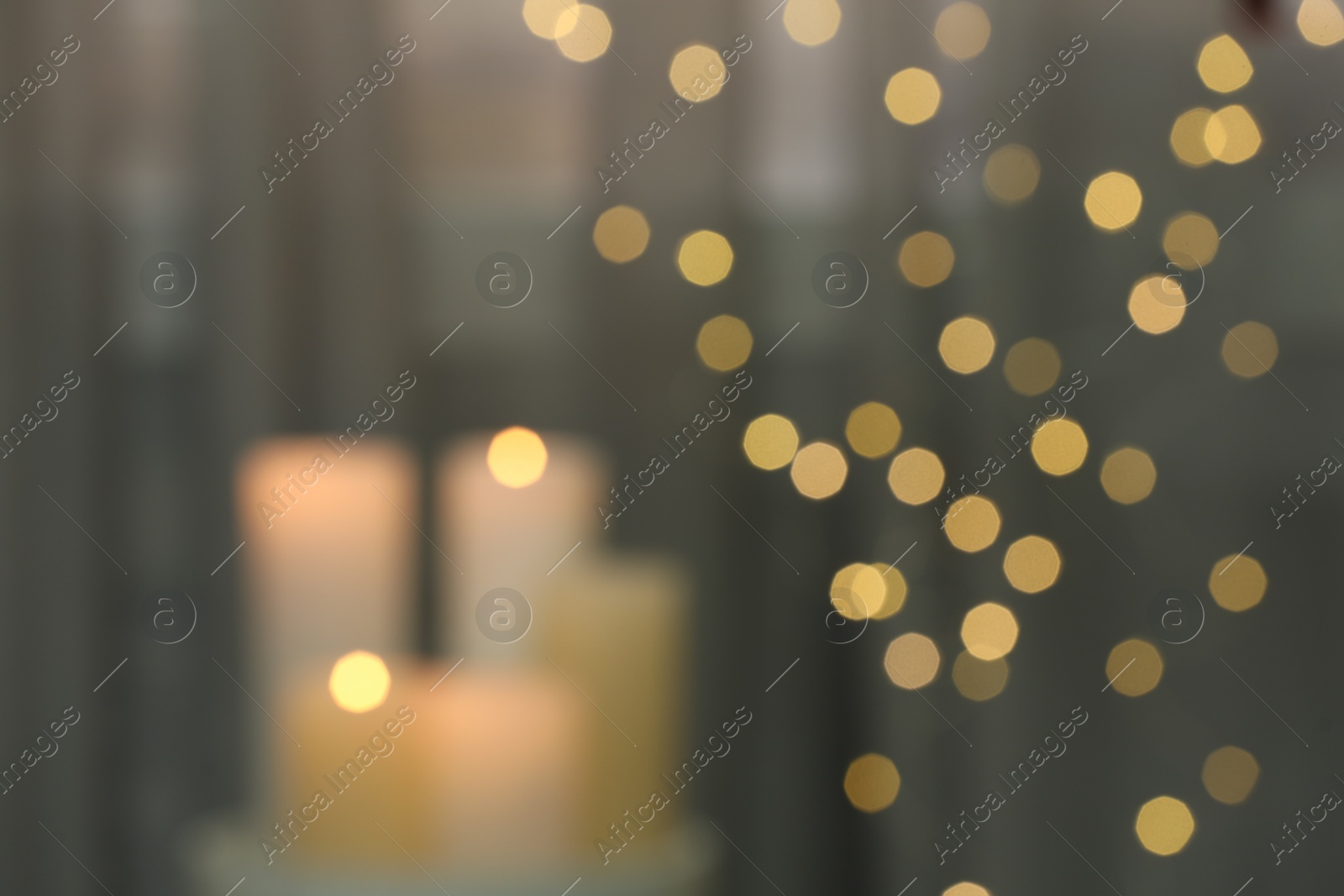 Photo of Blurred view of burning candles indoors. Bokeh effect