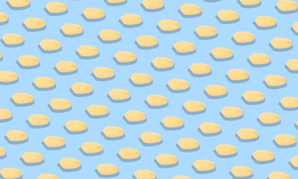 Image of Pattern of peeled peanuts on light blue background