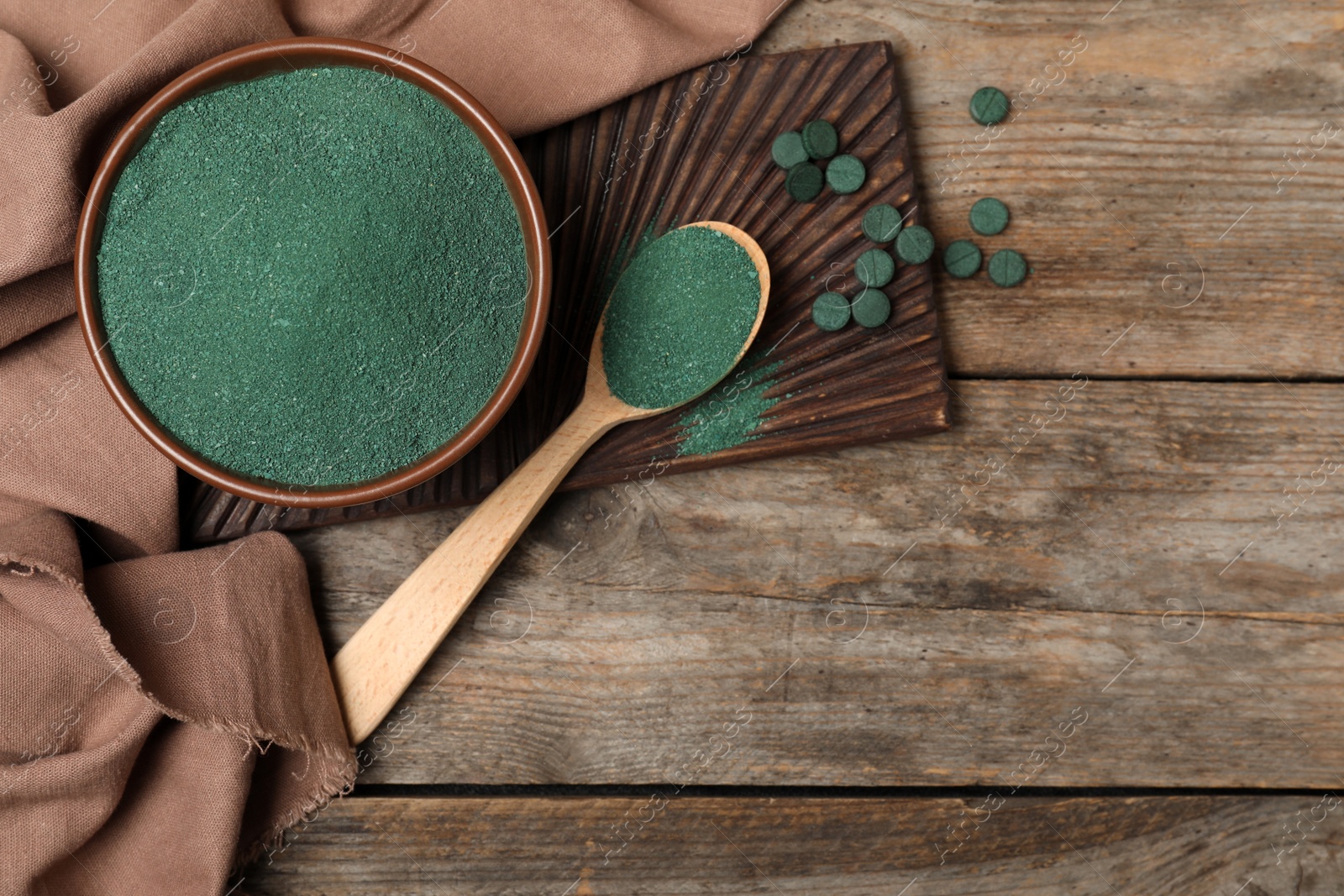 Photo of Flat lay composition with spirulina algae powder on wooden background, space for text