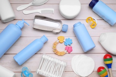 Flat lay composition with baby care products on white wooden table