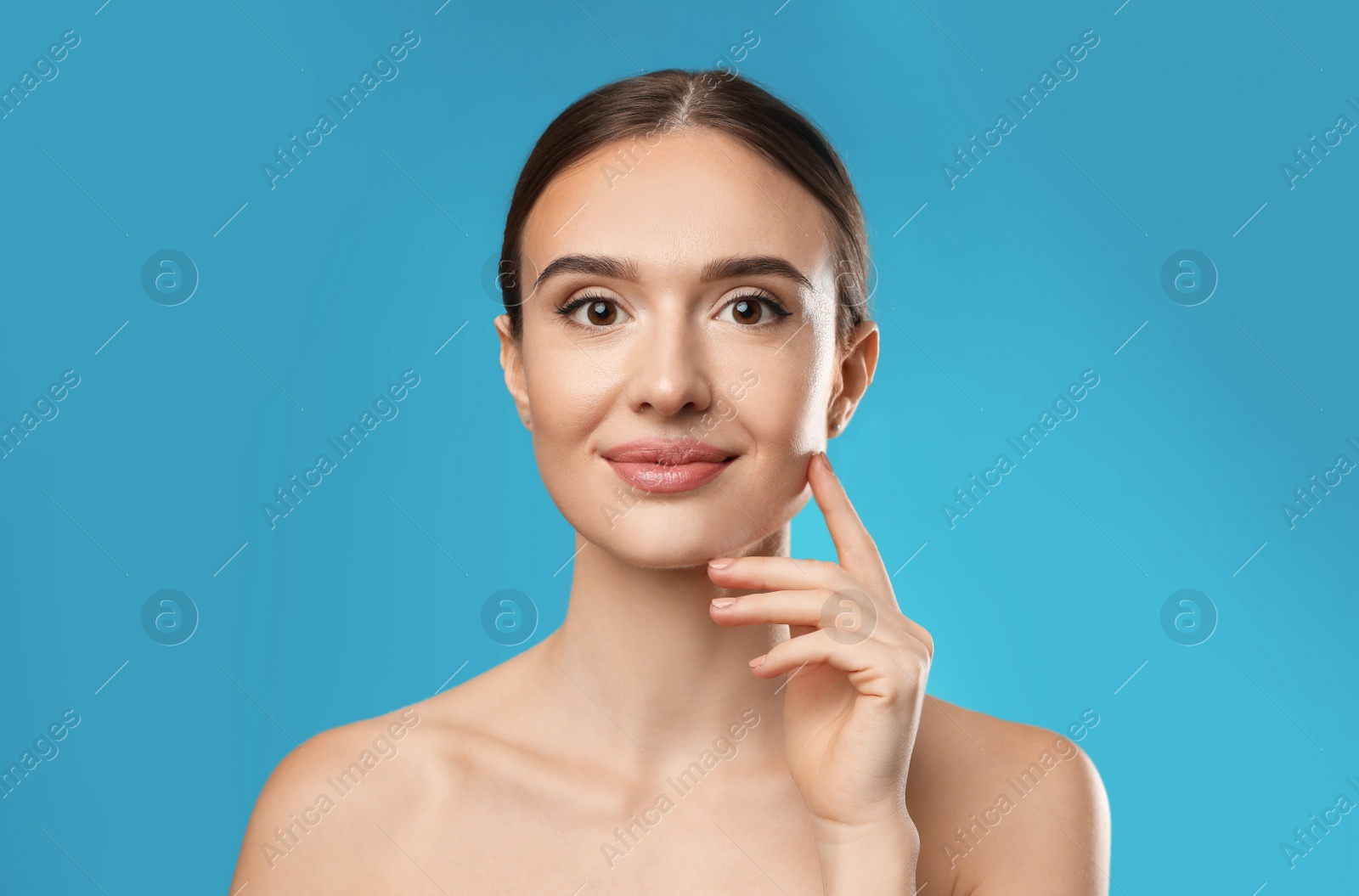 Photo of Beautiful woman with perfect smooth skin on light blue background