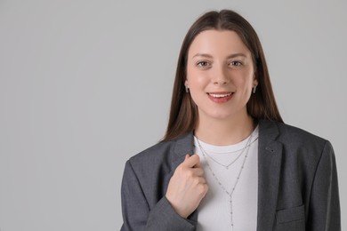 Photo of Portrait of beautiful young woman on light grey background