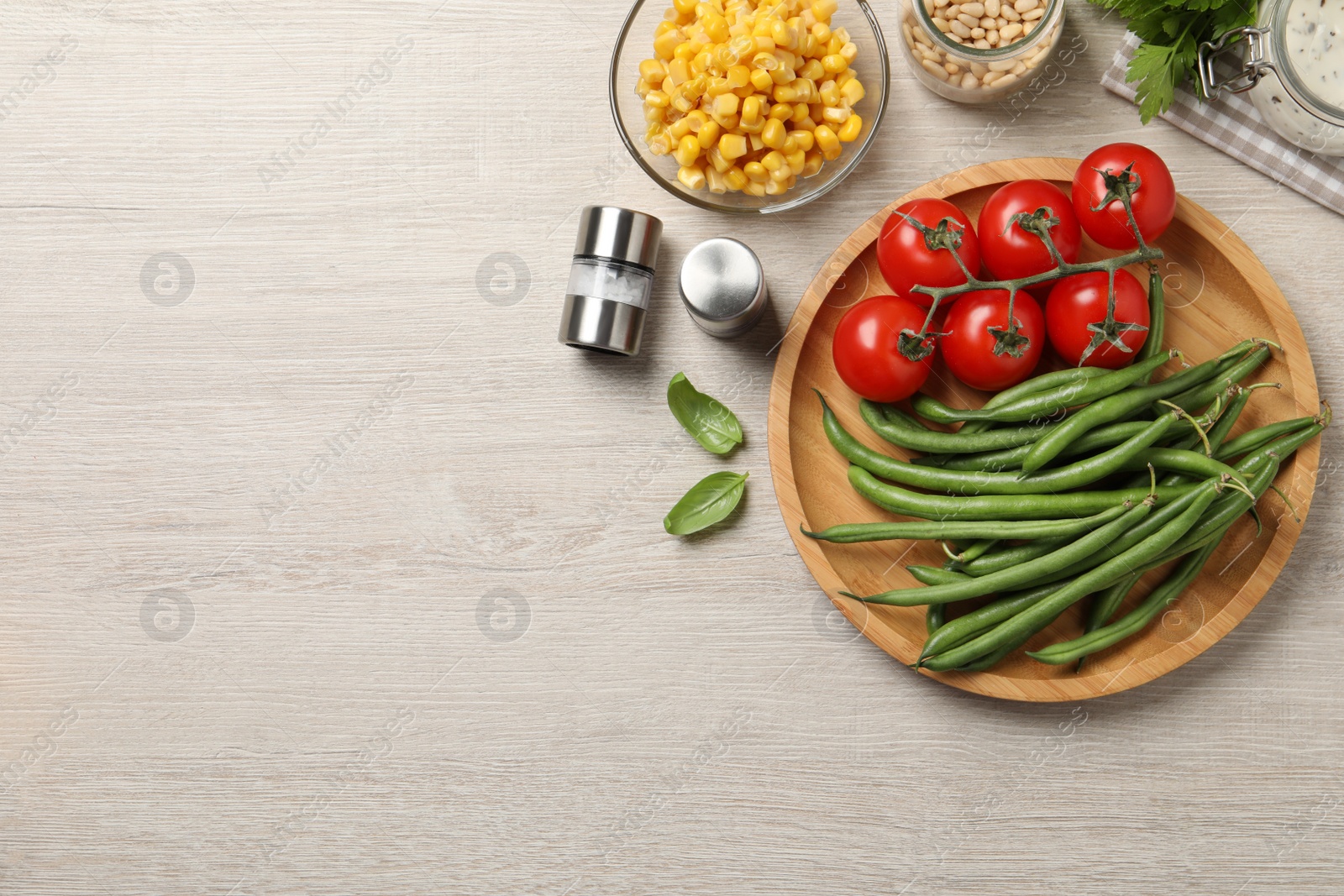 Photo of Fresh green beans and other ingredients on white wooden table, flat lay. Space for text