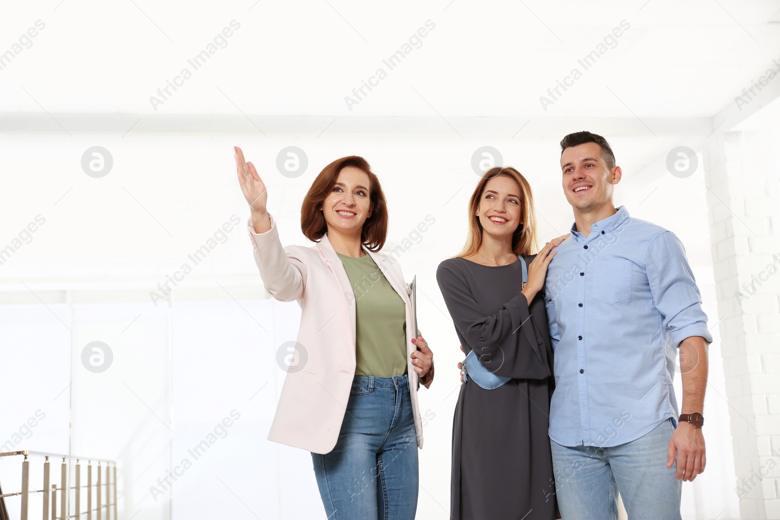 Photo of Real estate agent showing new apartment to young couple