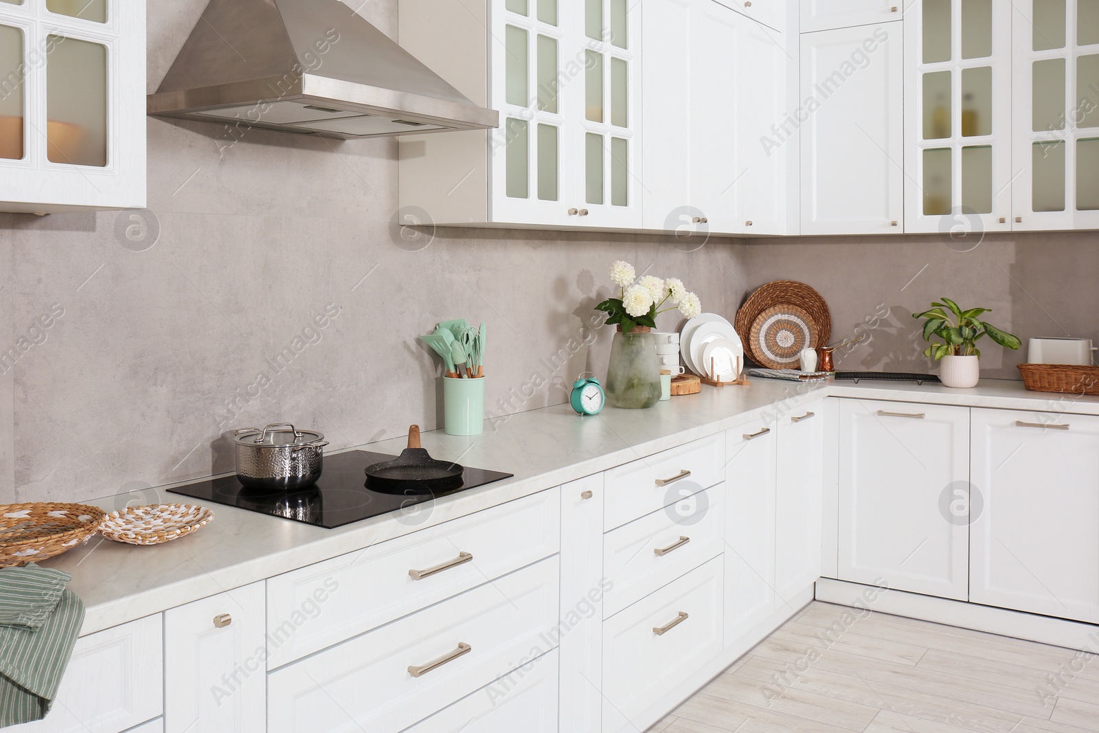 Photo of Beautiful kitchen interior with modern cooktop and stylish furniture