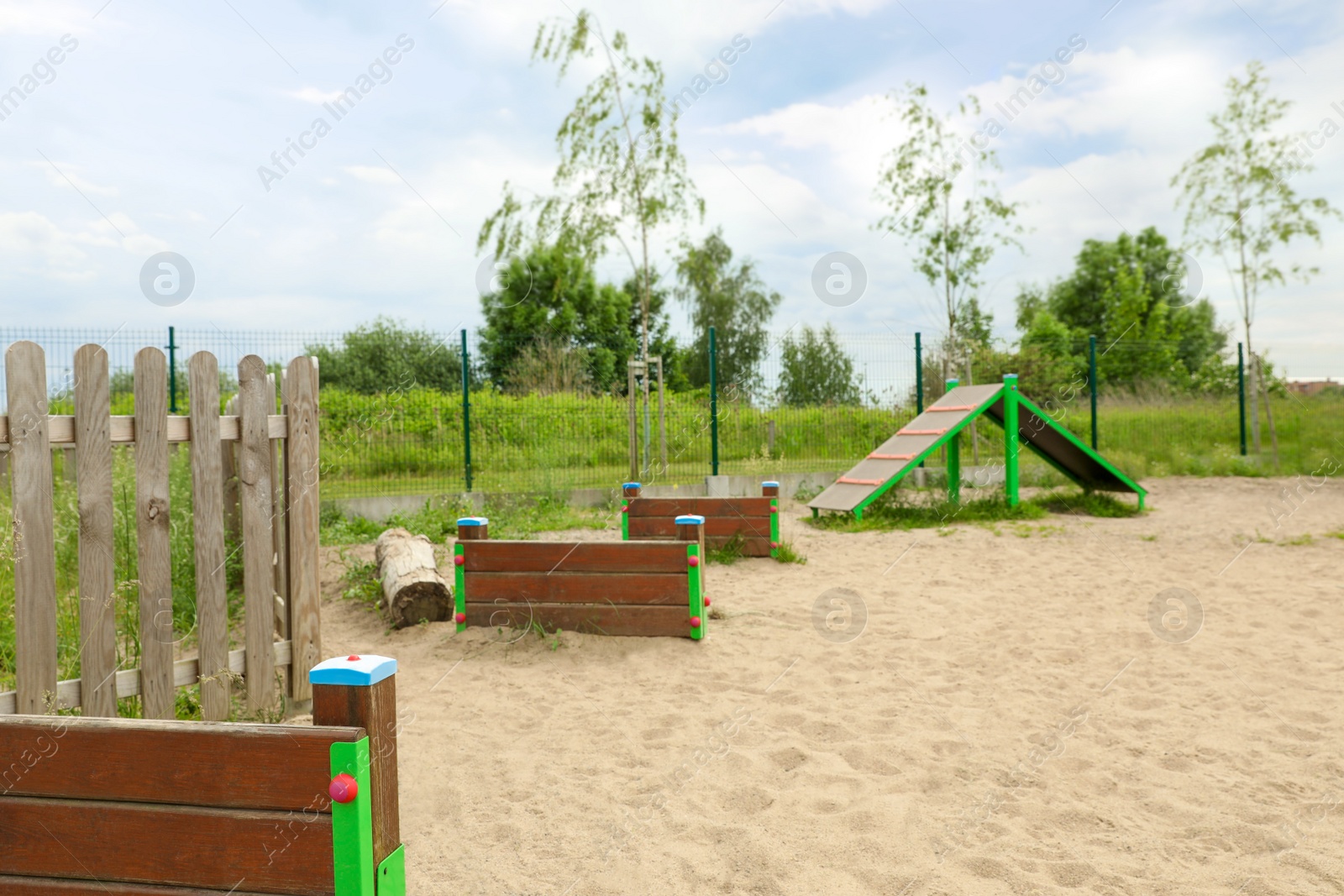 Photo of Wooden rover jump over and king of hill on animal training area outdoors