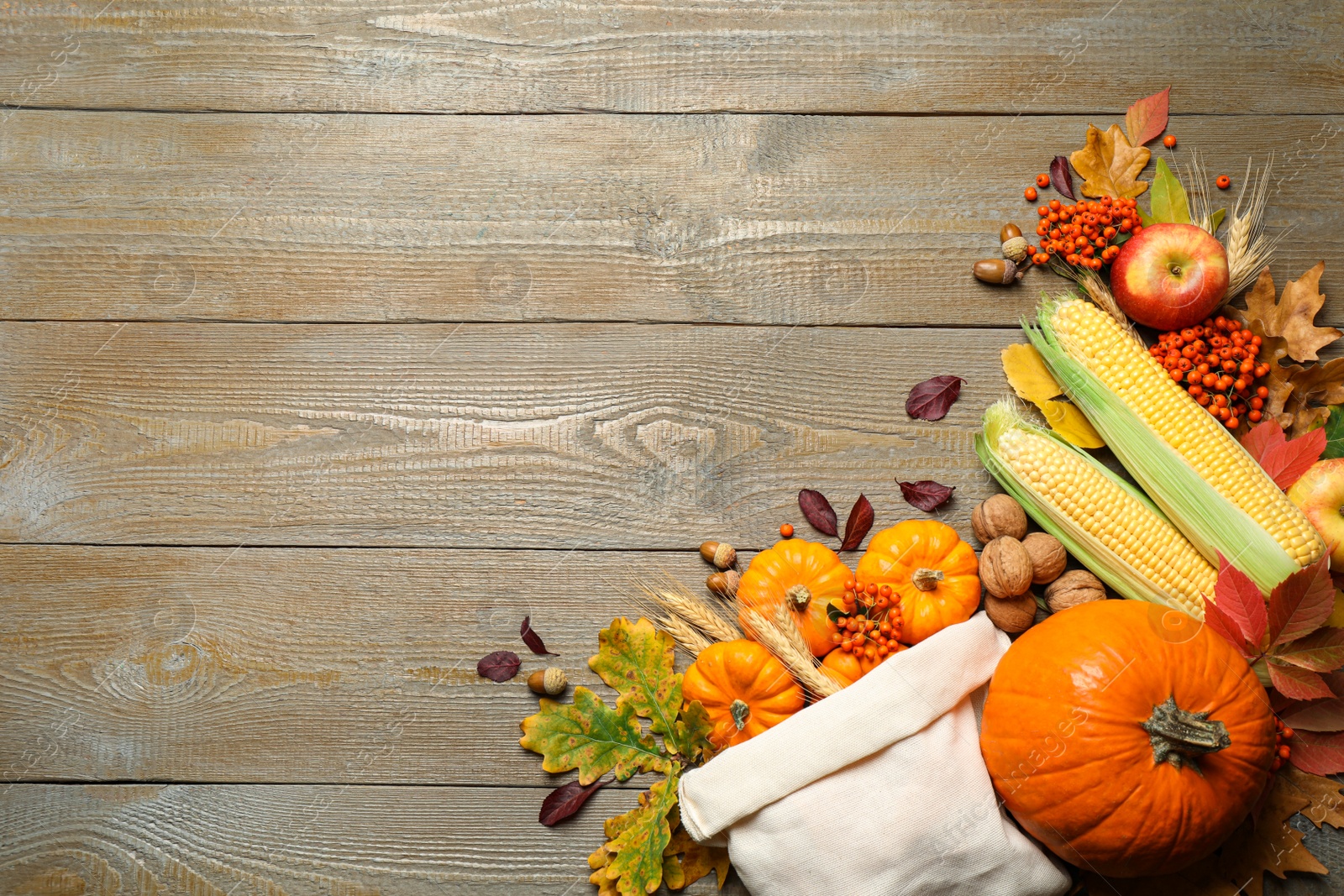 Photo of Flat lay composition with vegetables, berries and autumn leaves on wooden table, space for text. Thanksgiving Day