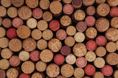 Many corks of wine bottles as background, top view