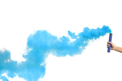 Photo of Woman with blue smoke bomb near white wall outdoors, closeup