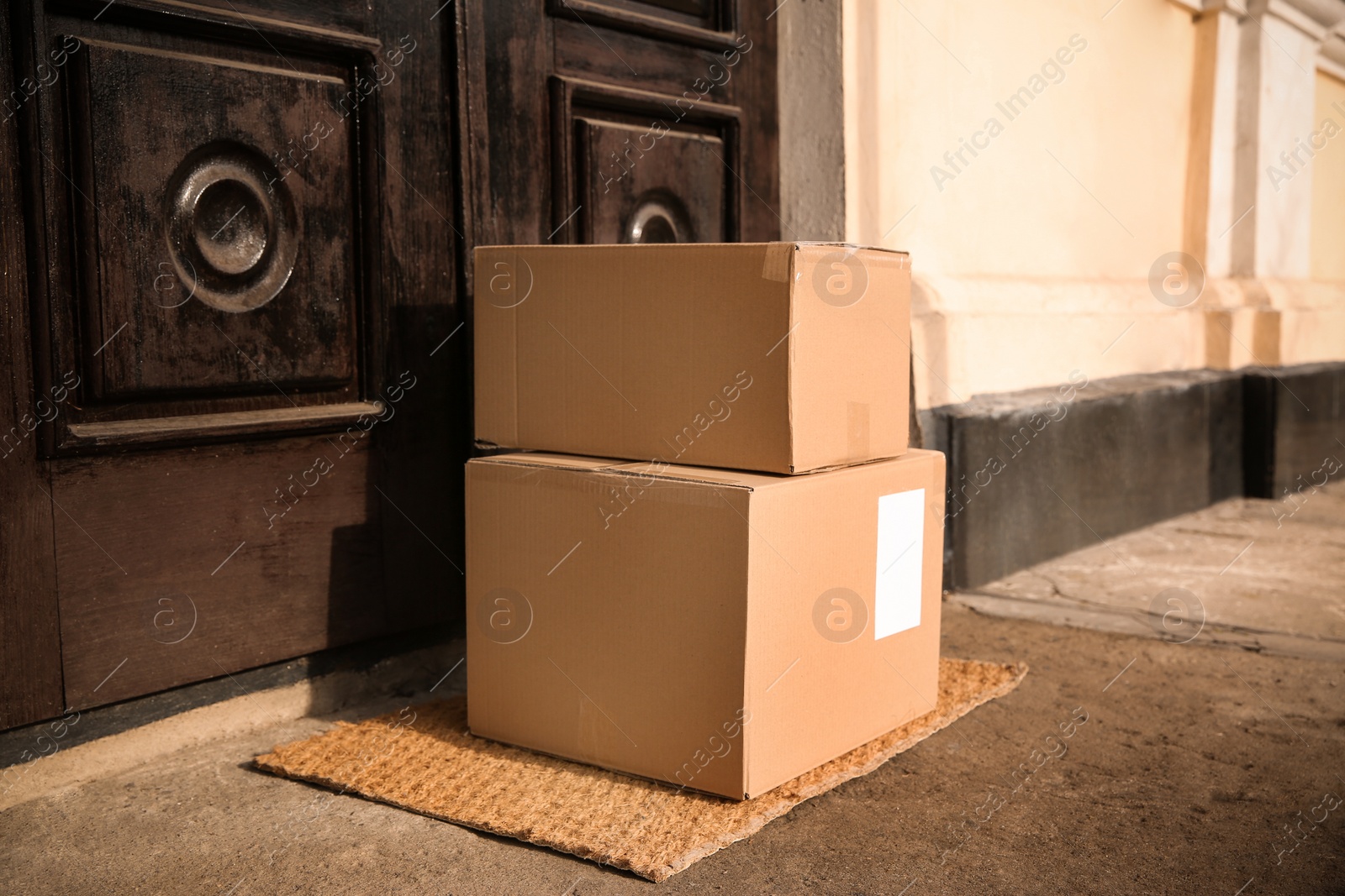 Photo of Delivered parcels on door mat near entrance