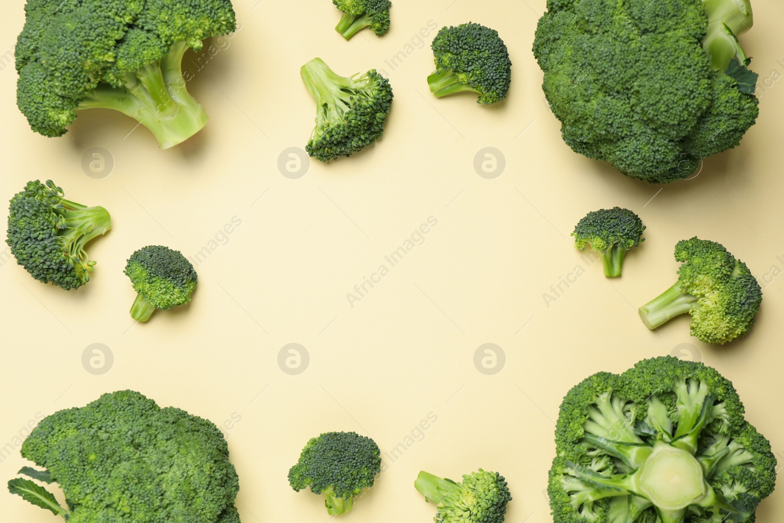 Photo of Fresh broccoli on beige background, flat lay. Space for text