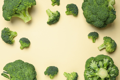 Photo of Fresh broccoli on beige background, flat lay. Space for text