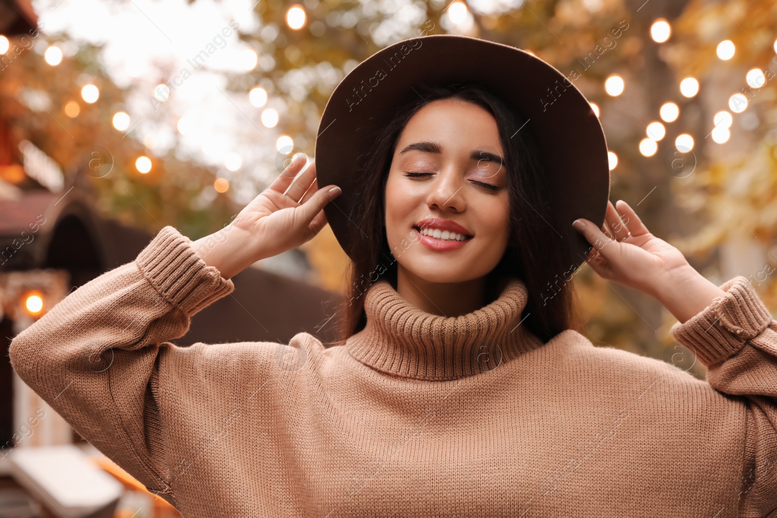 Photo of Young woman wearing stylish clothes outdoors. Autumn look