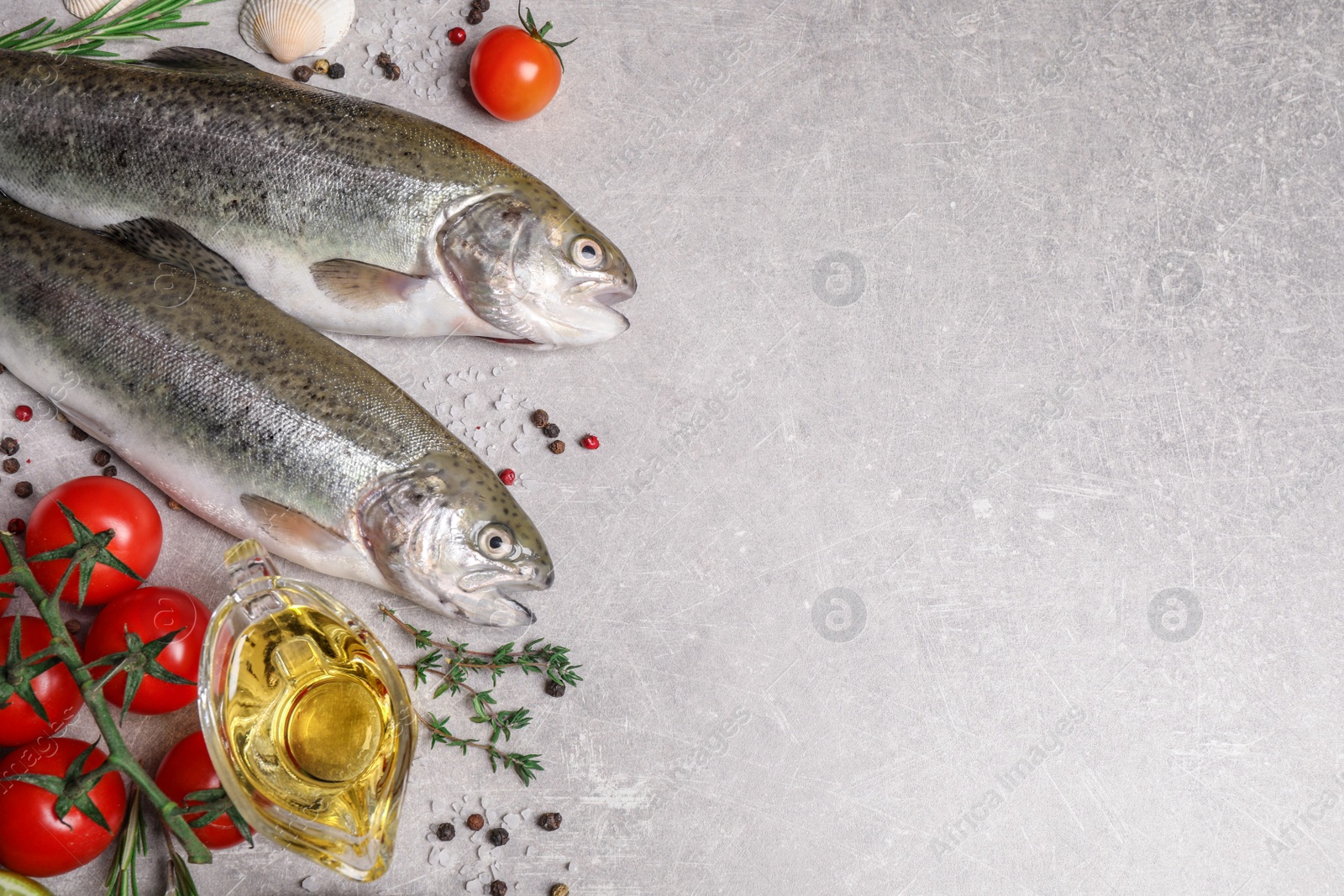 Photo of Flat lay composition with cutthroat fish on light grey table, space for text