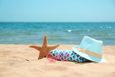 Photo of Set of different beach objects on sand near sea. Space for text