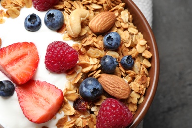 Photo of Tasty homemade granola served on grey table, closeup. Healthy breakfast