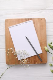 Photo of Guest list. Notebook, pencil and beautiful flowers on white wooden background, flat lay