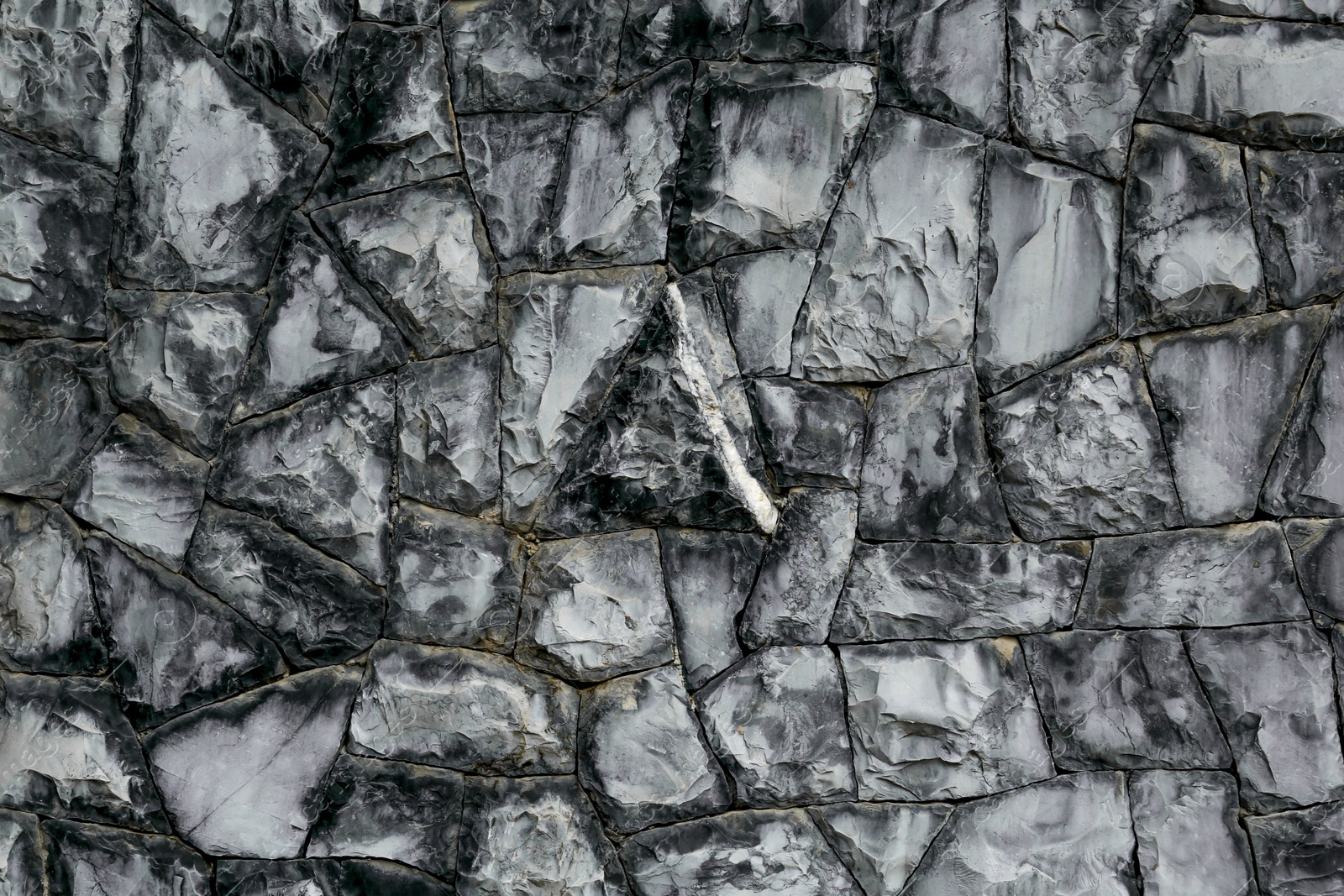 Photo of Texture of grey stone wall as background