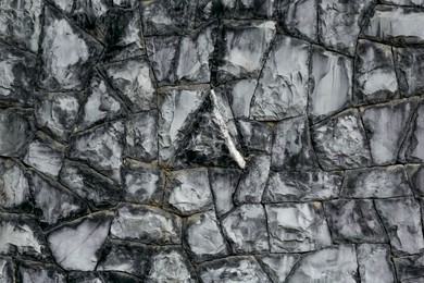 Photo of Texture of grey stone wall as background