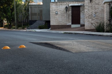 Photo of Speed bump on asphalt outdoors. Road safety