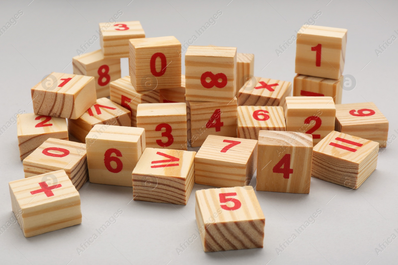 Photo of Wooden cubes with numbers and mathematical symbols on light background