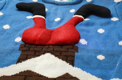 Photo of Funny Christmas sweater as background, closeup view
