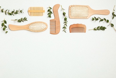 Photo of Flat lay composition with modern hair combs and brushes on white background. Space for text