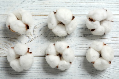 Photo of Flat lay composition with cotton flowers on white wooden background