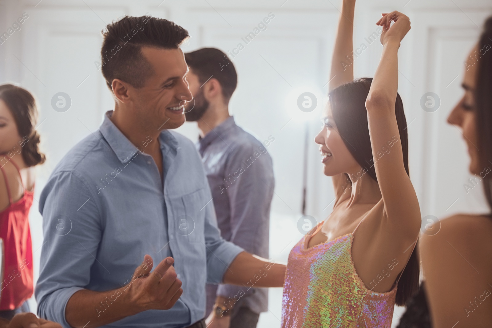 Photo of Lovely young couple dancing together at party