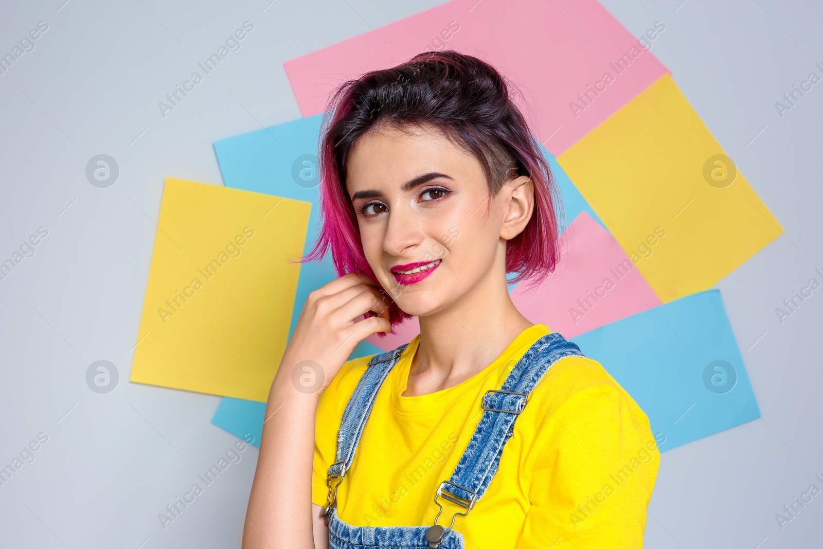 Photo of Young woman with trendy hairstyle against color background