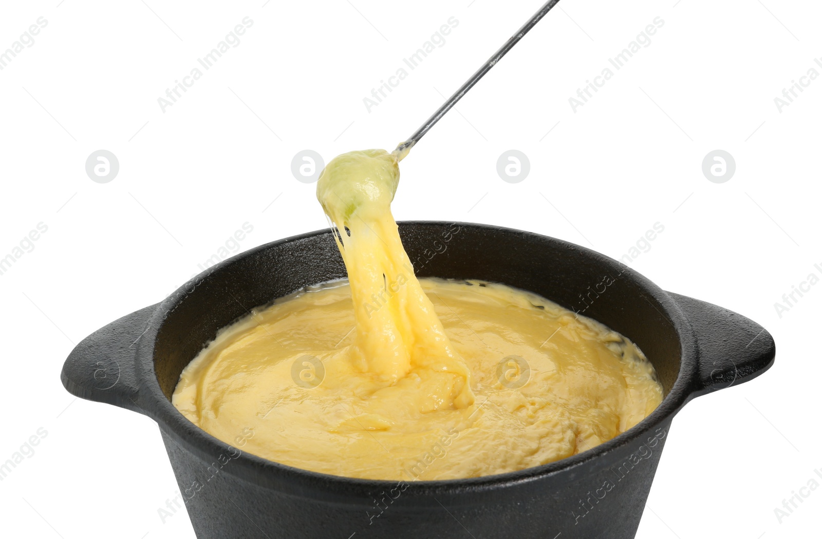 Photo of Dipping grape into fondue pot with tasty melted cheese isolated on white