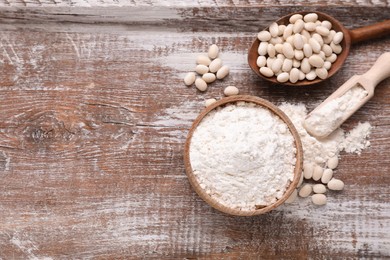 Photo of Bean flour and seeds on wooden table, flat lay. Space for text