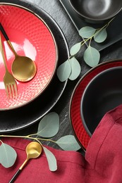 Photo of Flat lay composition with stylish ceramic plates and floral decor on grey table