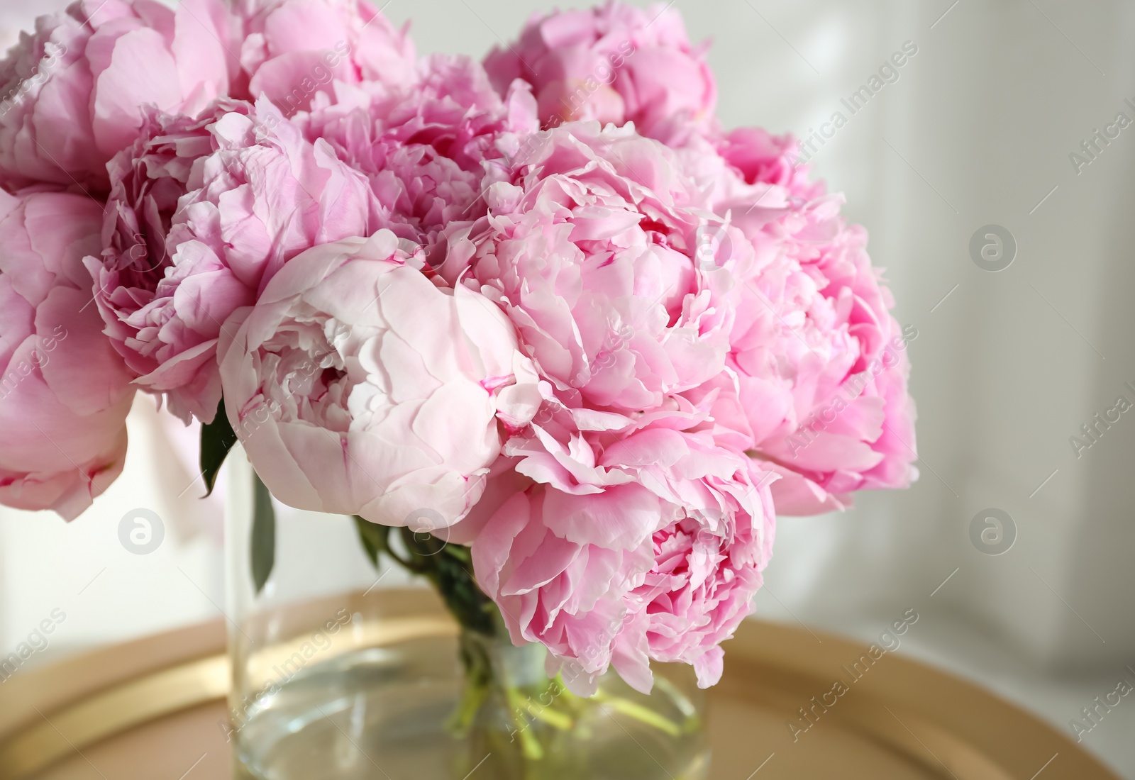 Photo of Bouquet of beautiful peonies on table indoors, closeup