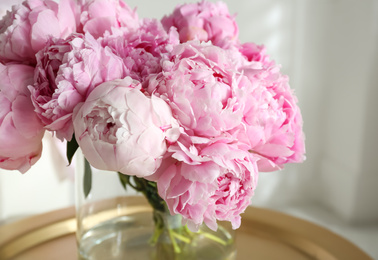 Bouquet of beautiful peonies on table indoors, closeup