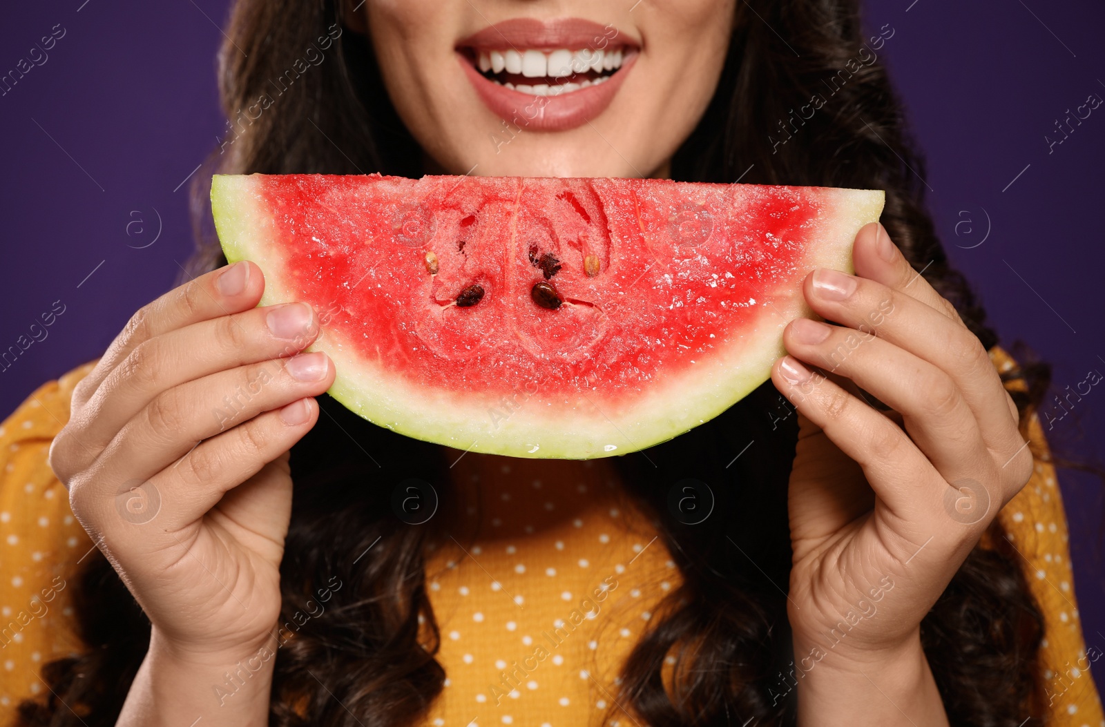 Photo of Beautiful young woman with watermelon on purple background, closeup