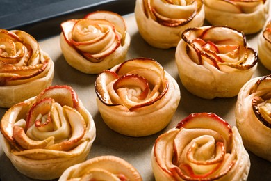 Tray with freshly baked apple roses, closeup. Beautiful dessert