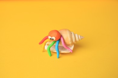 Crab made from plasticine on yellow background. Children's handmade ideas