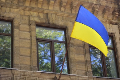Photo of National flag of Ukraine on old building wall outdoors