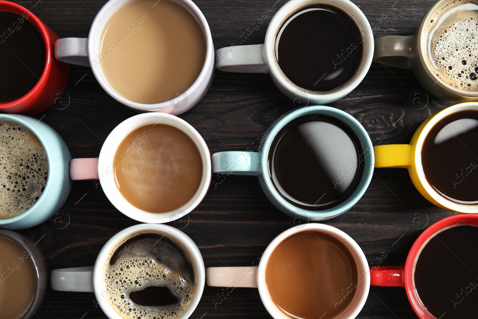 Photo of Cups of fresh aromatic coffee on dark background, top view. Food photography