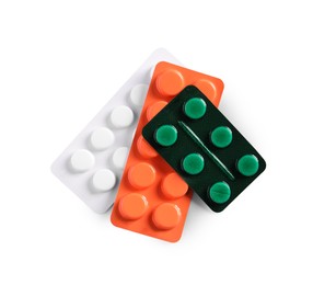 Blisters with different pills on white background, top view