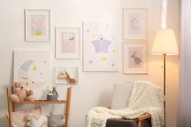 Stylish child's room interior with comfortable armchair and beautiful pictures