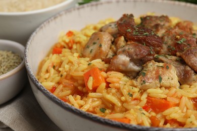 Photo of Delicious pilaf with meat in white bowl, closeup