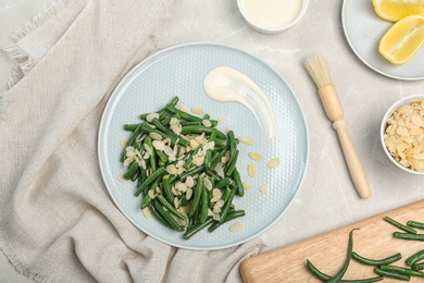 Photo of Tasty green beans with almonds served for dinner on table, top view