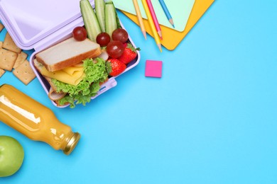 Photo of Lunchbox with tasty food, juice and school stationery on light blue background, flat lay. Space for text