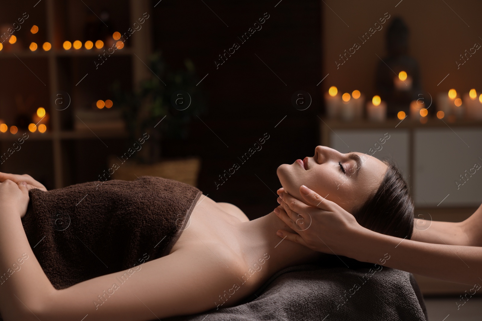 Photo of Spa therapy. Beautiful young woman lying on table during massage in salon