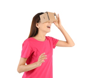 Photo of Young woman using cardboard virtual reality headset, isolated on white