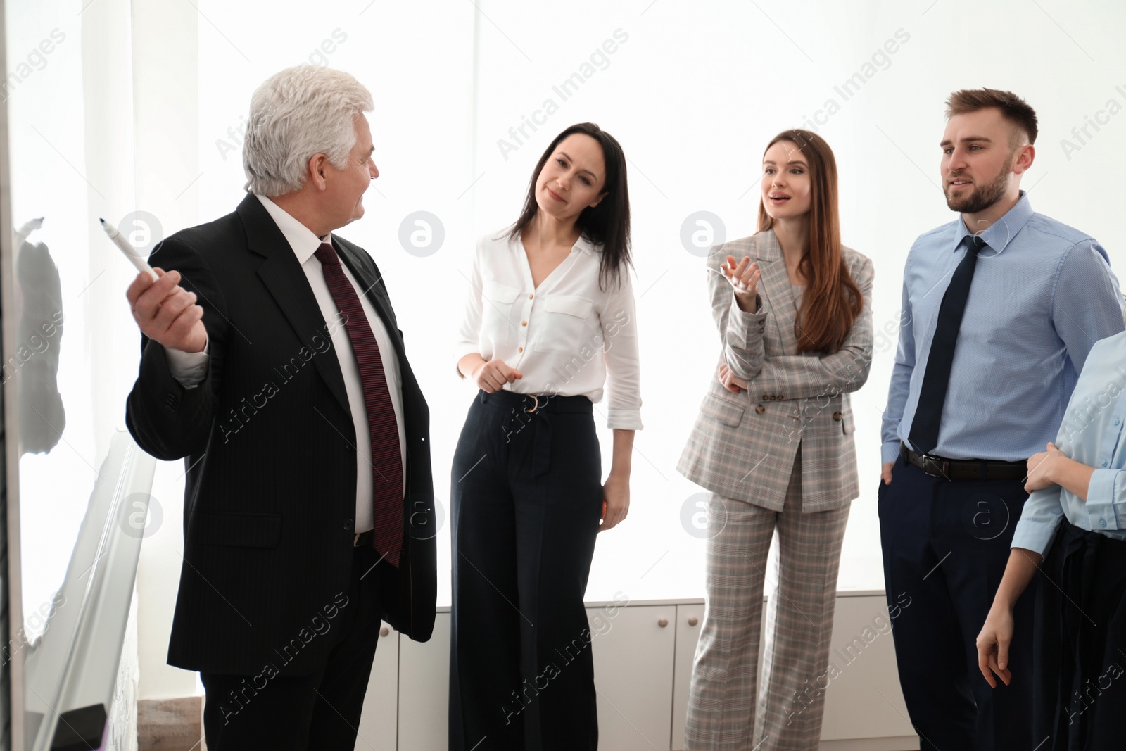 Photo of Professional business trainer working with people in office