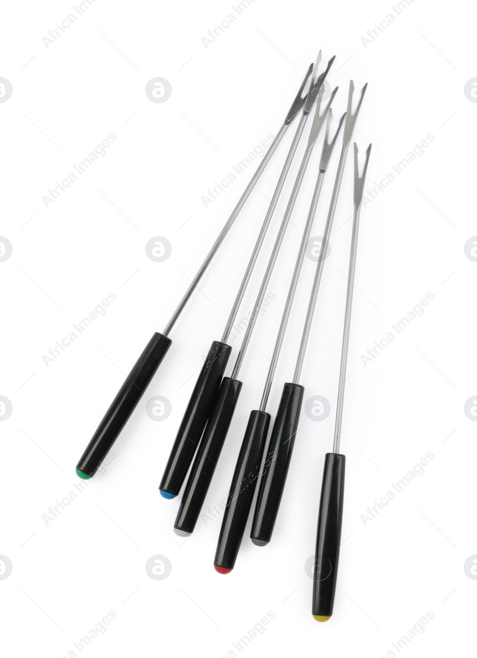 Photo of Set of fondue forks isolated on white, top view. Kitchen equipment